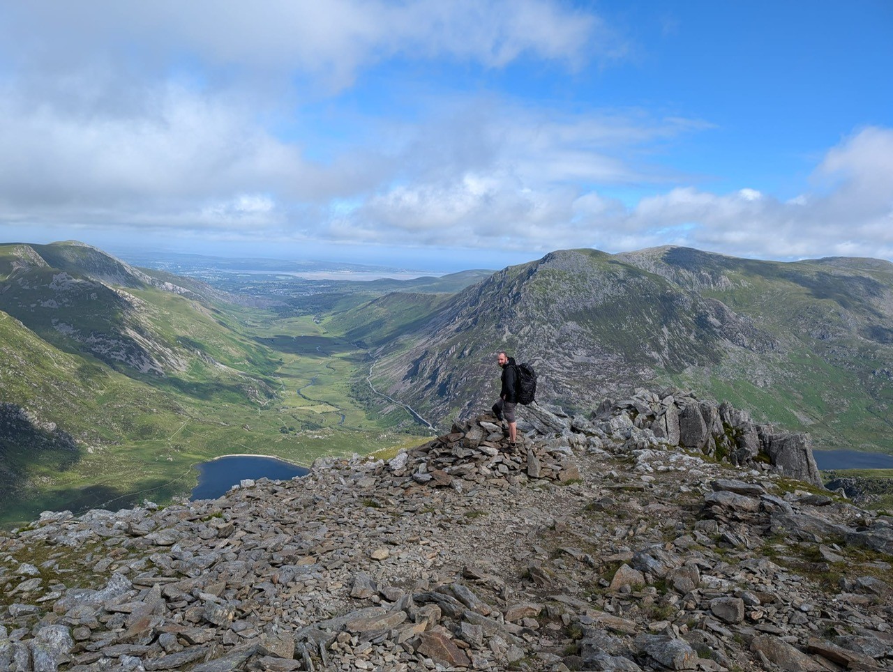 Chay Coulbert crossing a high mountain ridge above a glacial valley