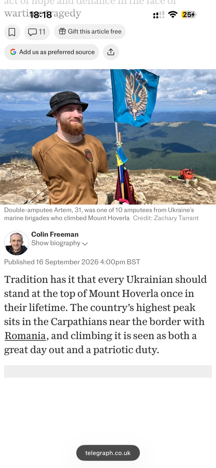 Artem standing beside the Ukrainian Marines flag on the summit of Mount Hoverla